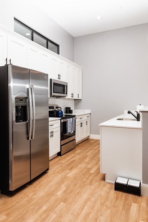 a kitchen with stainless steel appliances and white cabinets