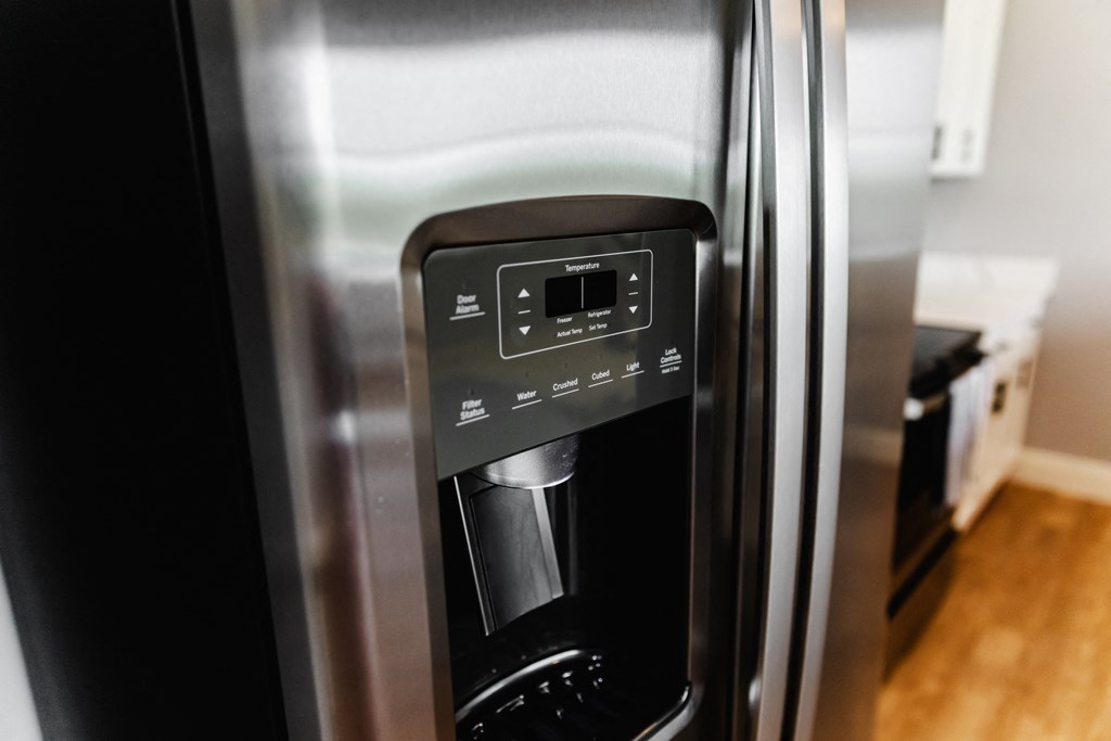 a kitchen with a refrigerator freezer next to a stove
