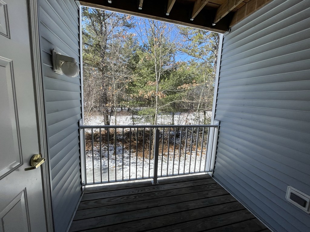 the view from the porch of a cabin with a balcony overlooking a river