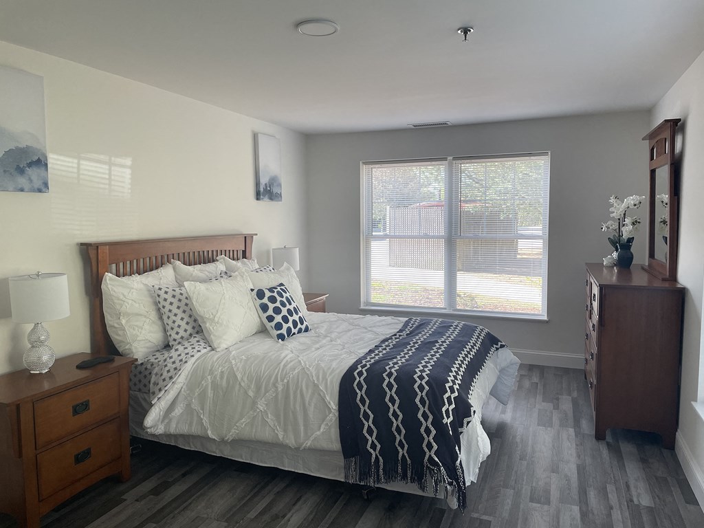 a bedroom with a large bed and a window