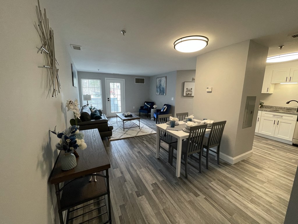 an open living room and dining room with a table and chairs