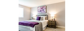 a bedroom with a bed and two night stands with lamps