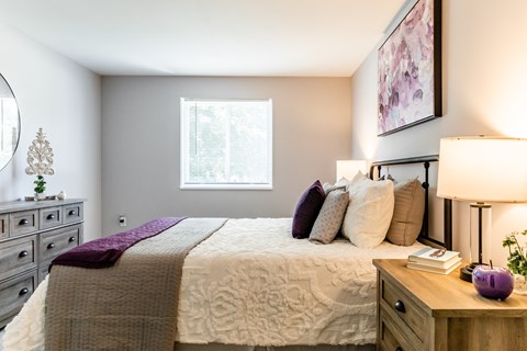 a bedroom with a bed and dresser