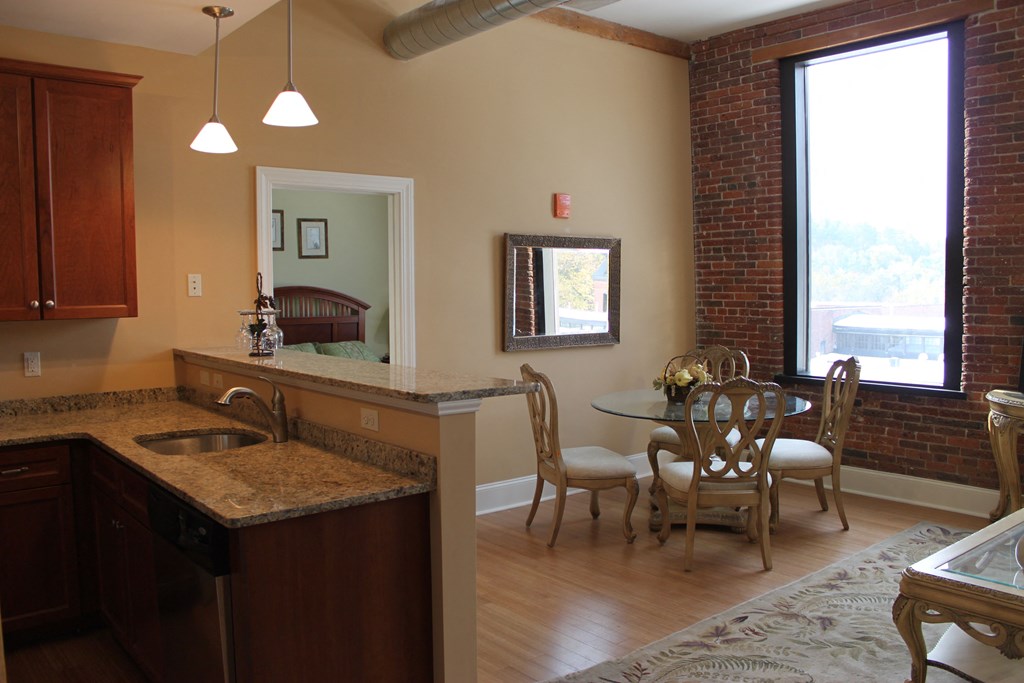 an open kitchen and dining room with a table and chairs