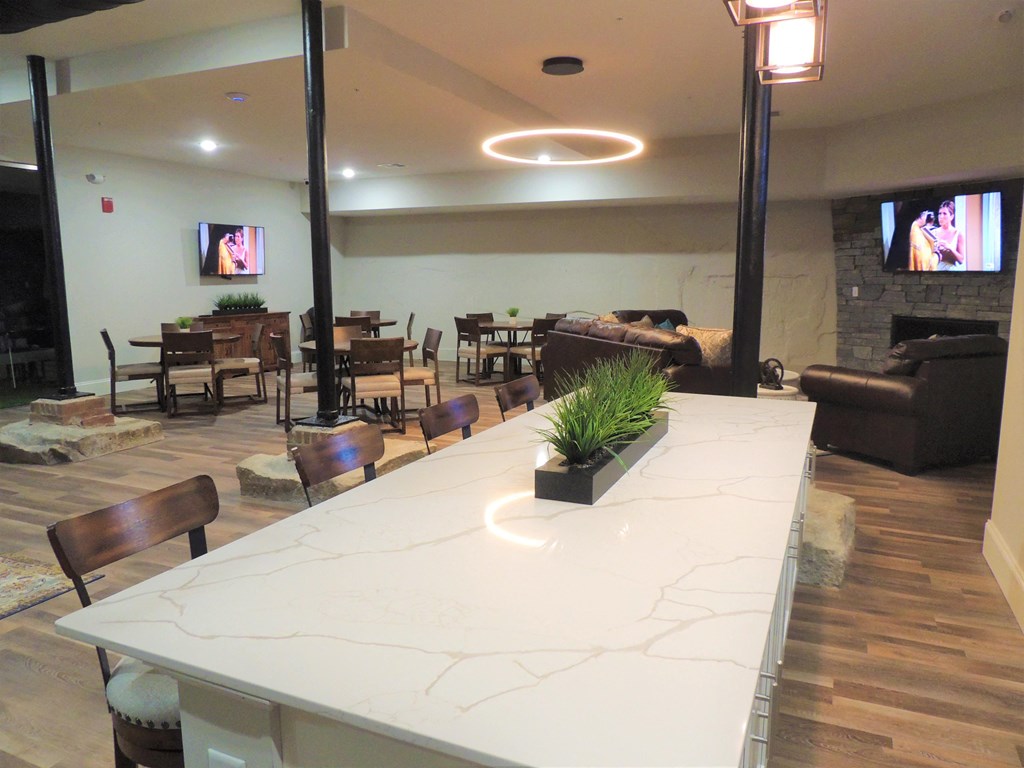 a large table with chairs in a living room with a fireplace