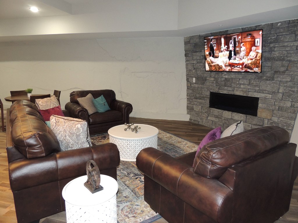 a living room with leather couches and a television