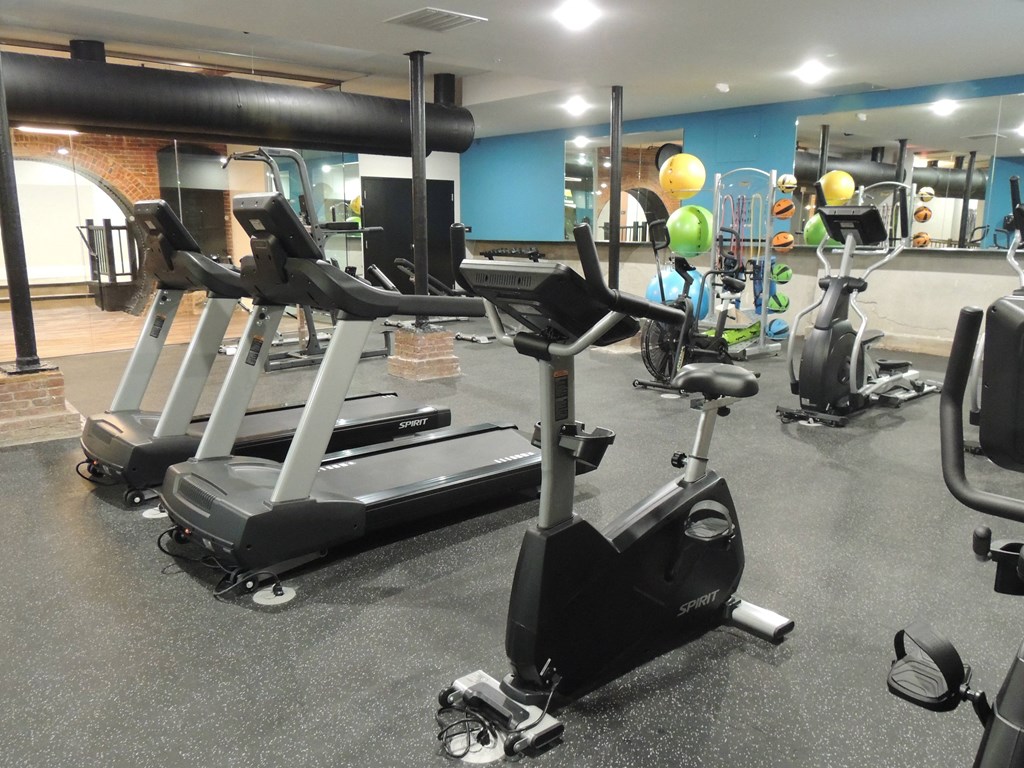 a group of exercise machines in a gym