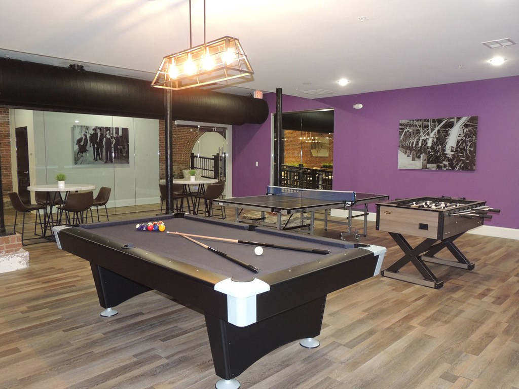 a game room with a pool table and a billiards table