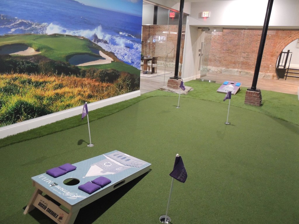 a mini golf course in a building with a view of the ocean