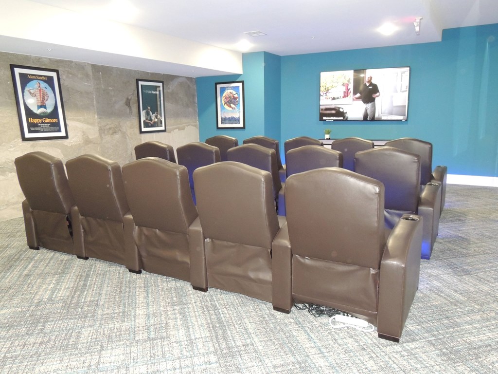 a conference room with blue walls and brown leather chairs