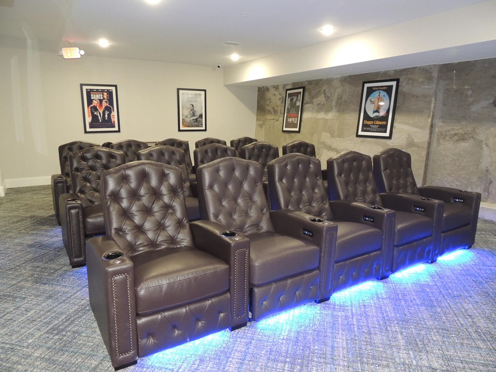 a row of leather chairs in a living room with blue lights