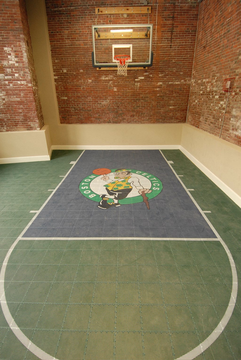 a mural of a person on the floor of a basketball court