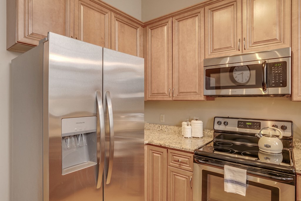 a kitchen with stainless steel appliances and wooden cabinets