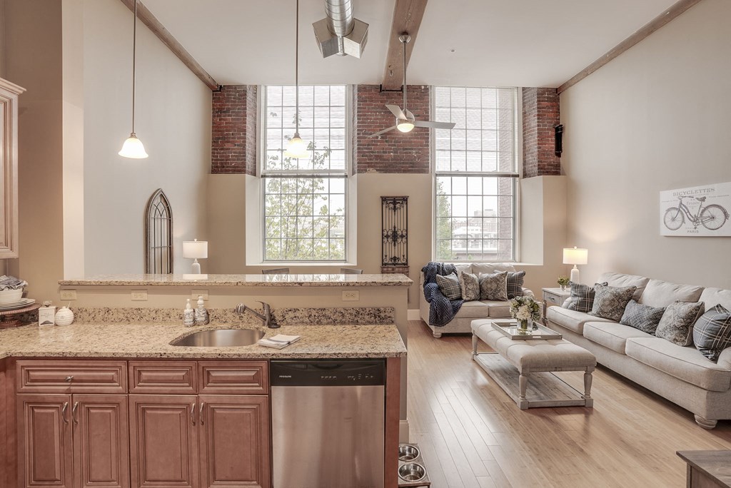 a living room with a kitchen and a couch and a table