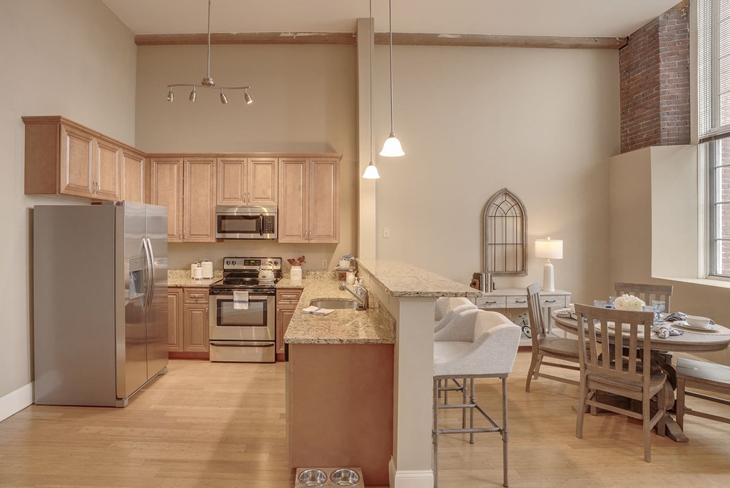a kitchen and dining room with a table and chairs
