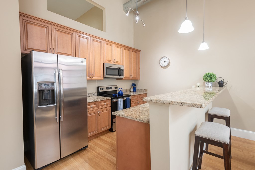 a kitchen with stainless steel appliances and granite counter tops