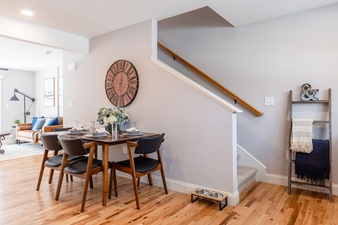 A dining room with a wooden table and chairs.