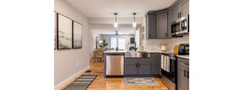 A modern kitchen with a large island and stainless steel appliances.