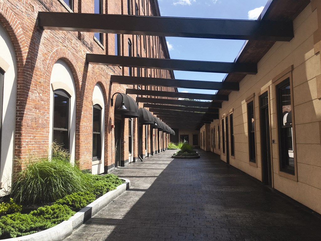 a walkway between two buildings in a courtyard