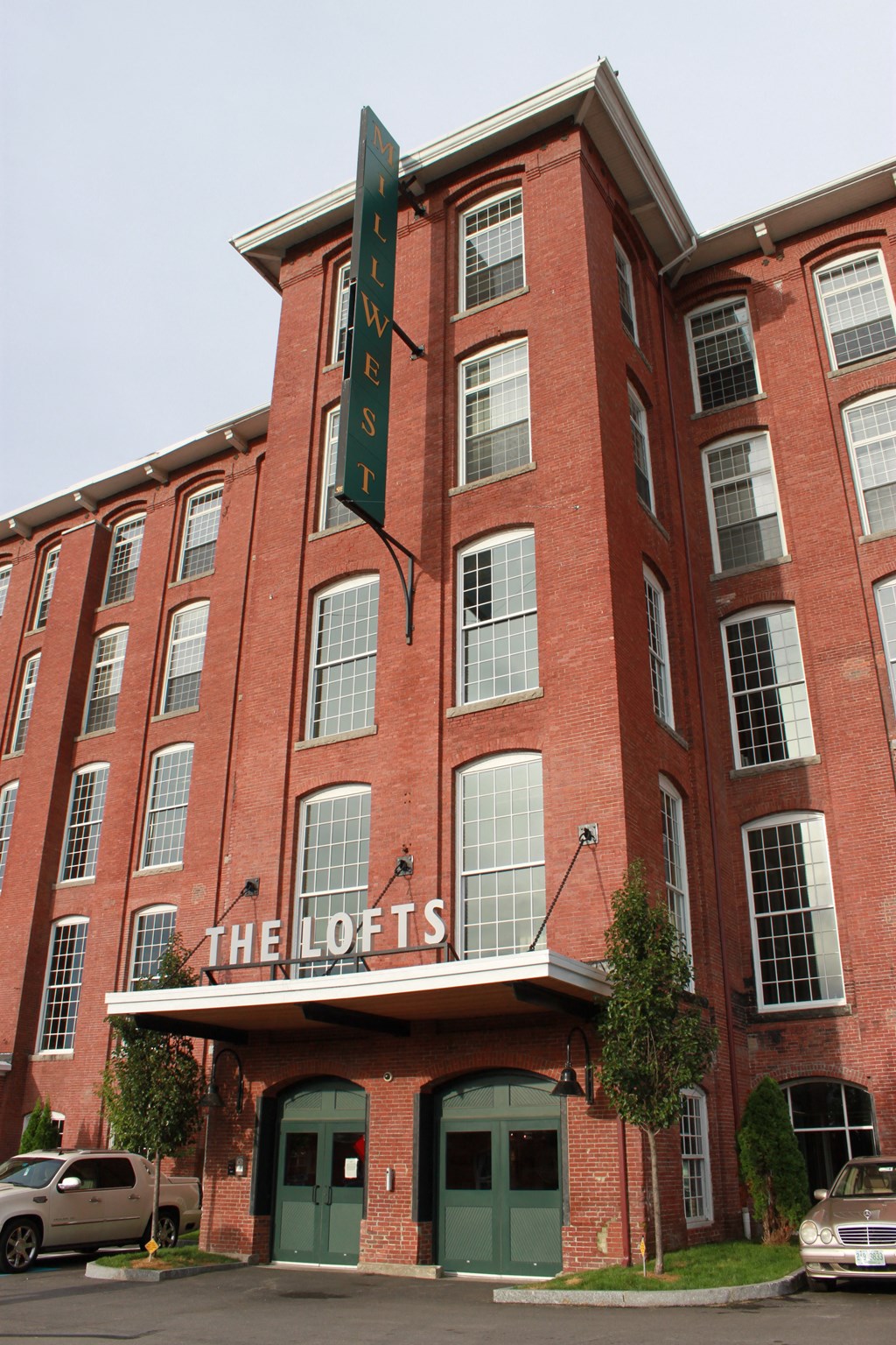 a large red brick building with a sign that reads the lofts