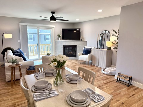 A dining room with a table set for a meal.