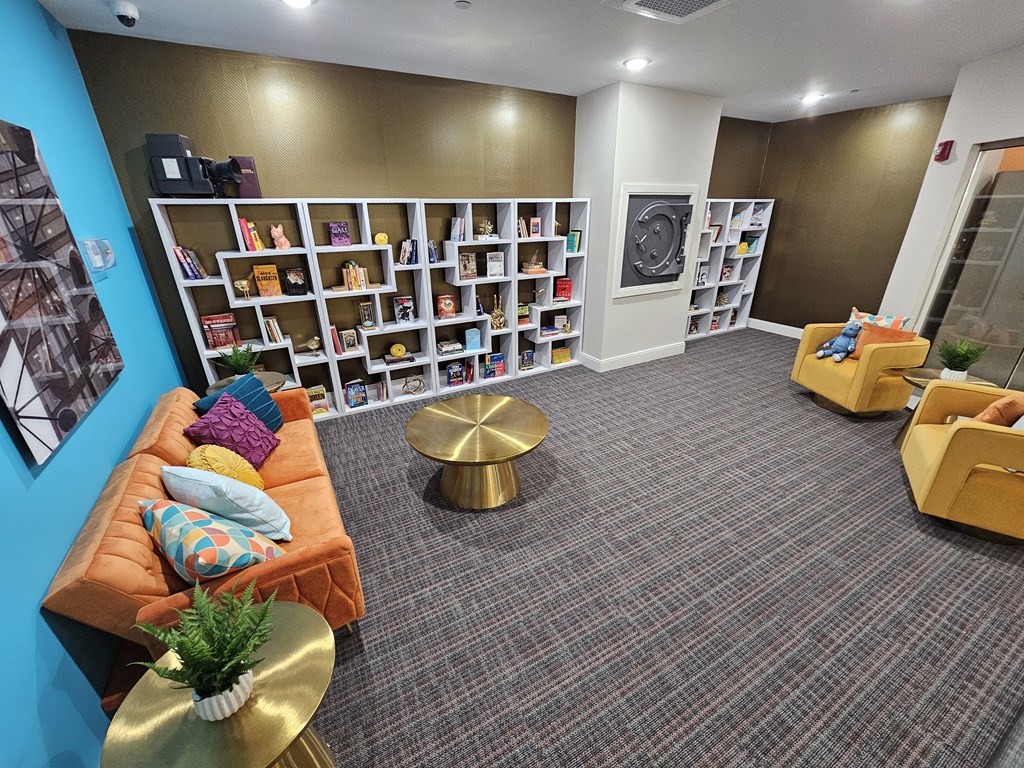 a living room with a couch and a book shelf