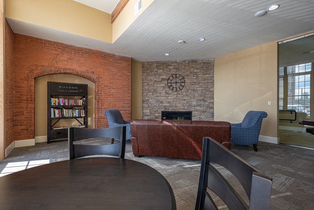 a living room with a table and chairs and a fireplace