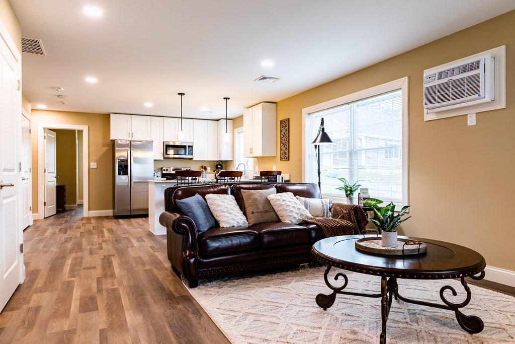 a living room with brown leather couches and a coffee table