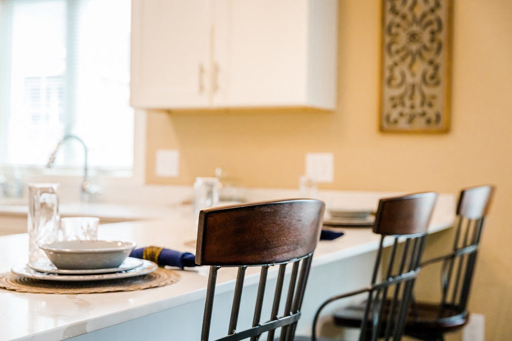 a kitchen with a table and three chairs