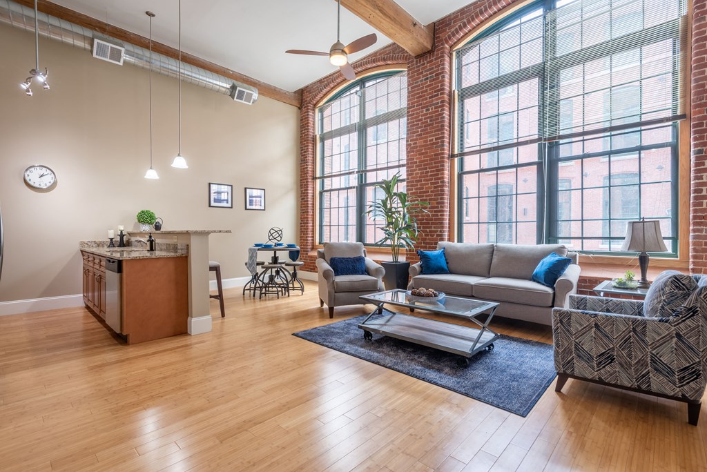 an open living room with large windows and a couch and a coffee table