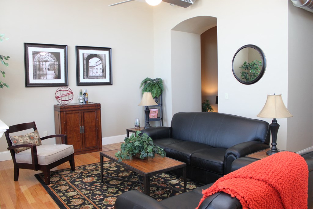 a living room with a leather couch and a coffee table