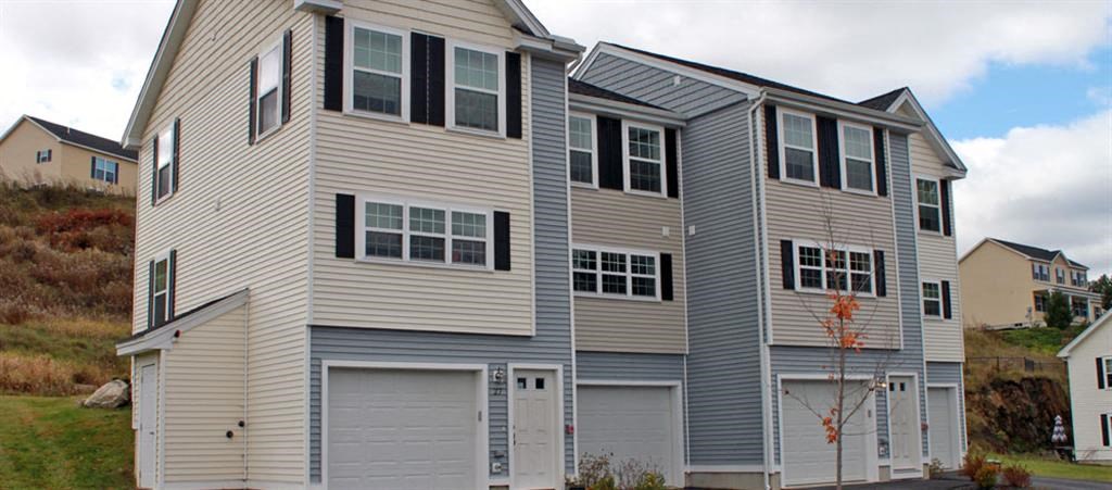 a large gray house with a garage