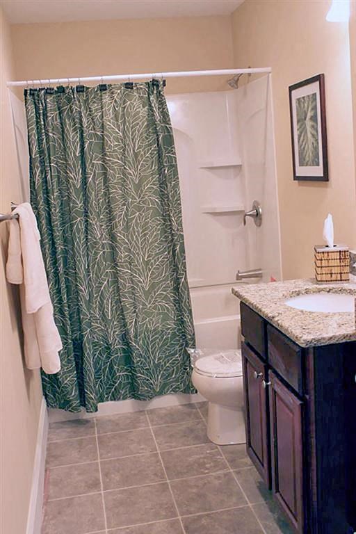 a bathroom with a shower curtain and a toilet