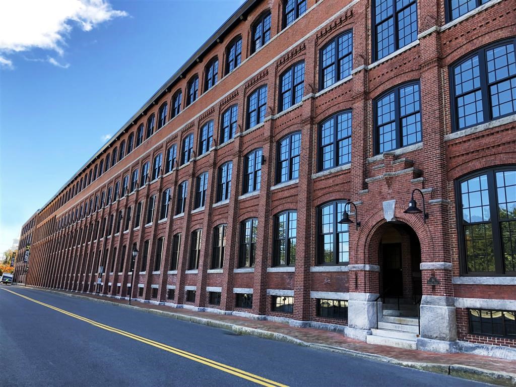 a large brick building on the side of a street