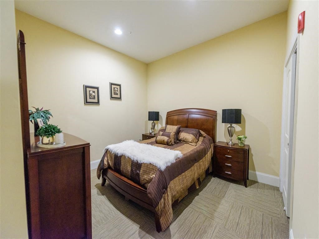 a bedroom with a bed and two dressers