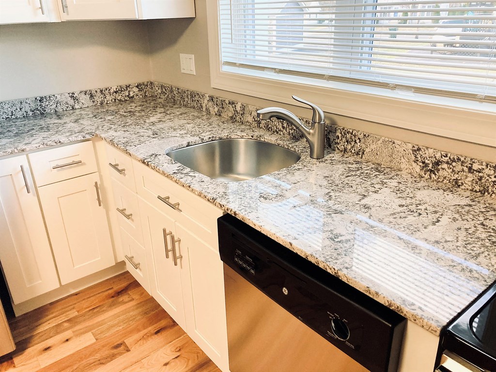 a kitchen with granite counter tops and a sink