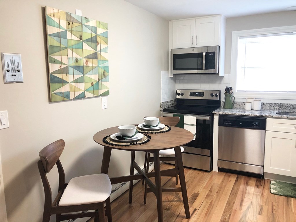 a small kitchen with a small table and chairs