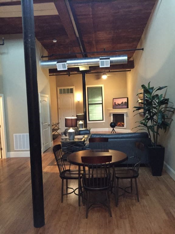 a dining room and living room with a table and chairs
