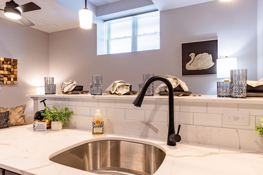 A kitchen with a sink and a window.