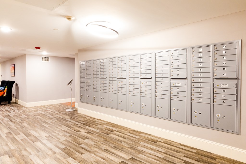a lockers room in a building with wood flooring and white walls