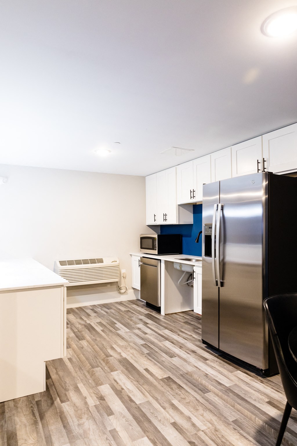 a kitchen with stainless steel appliances and white cabinets