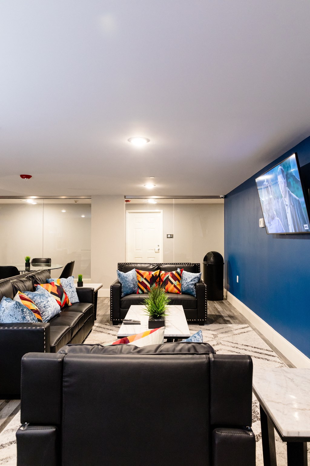 a living room with couches and a table and a tv