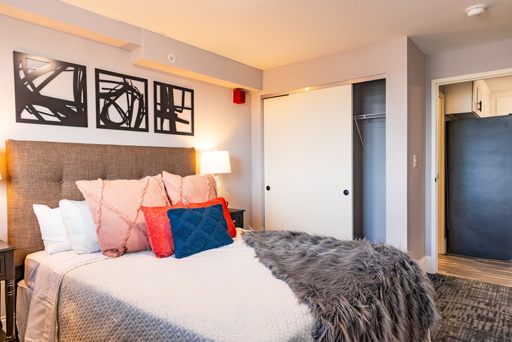 a bedroom with a large bed and a door to a bathroom