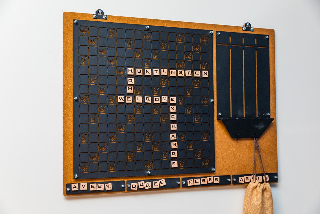 a wooden game board with numbers on it and a shovel