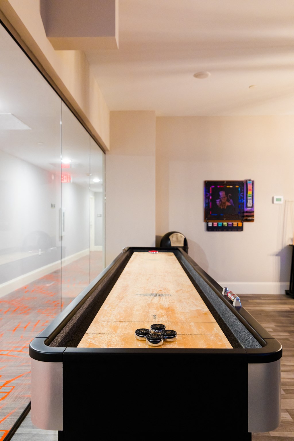 a ping pong table in a game room with a glass wall