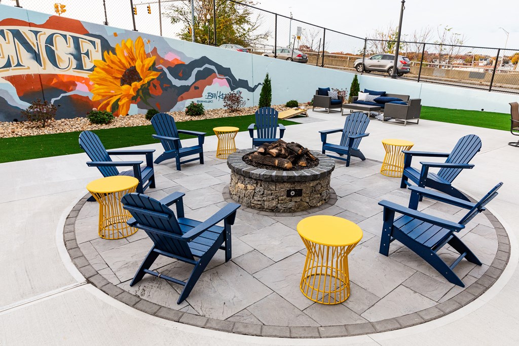 an outdoor patio with chairs and a fire pit