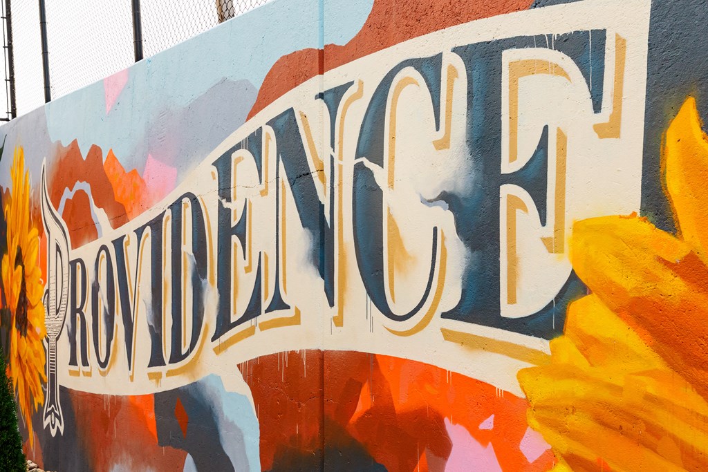 a mural on the side of a building with the word cowboy painted on it