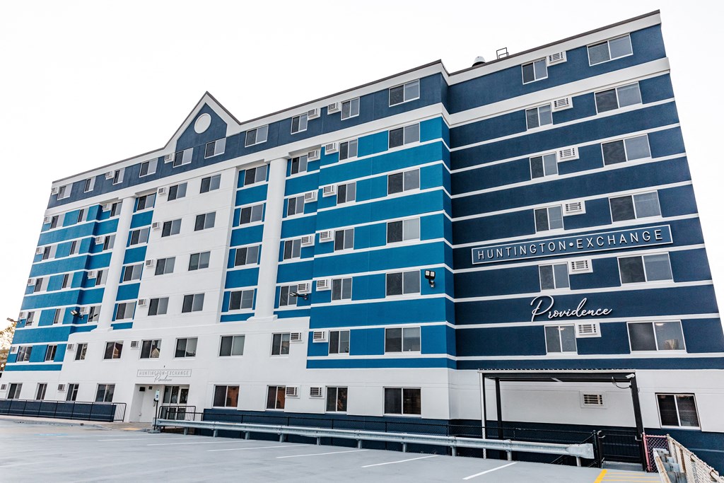 a blue and white building in front of a parking lot