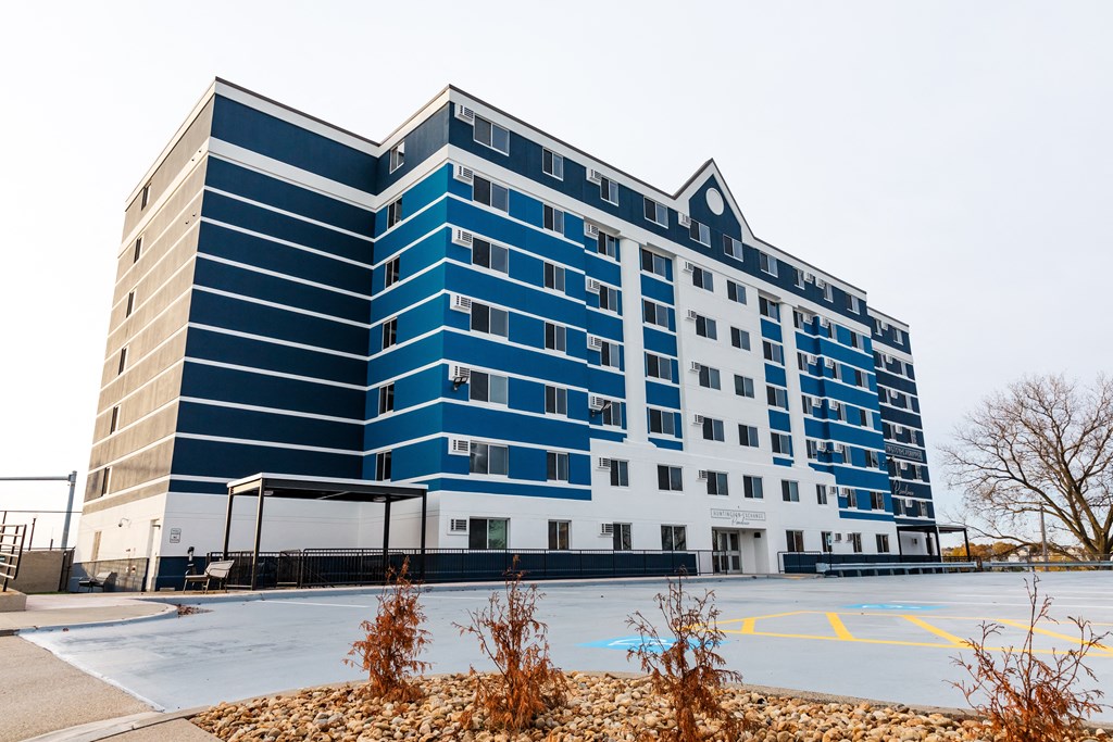 a blue and white building on the corner of a parking lot