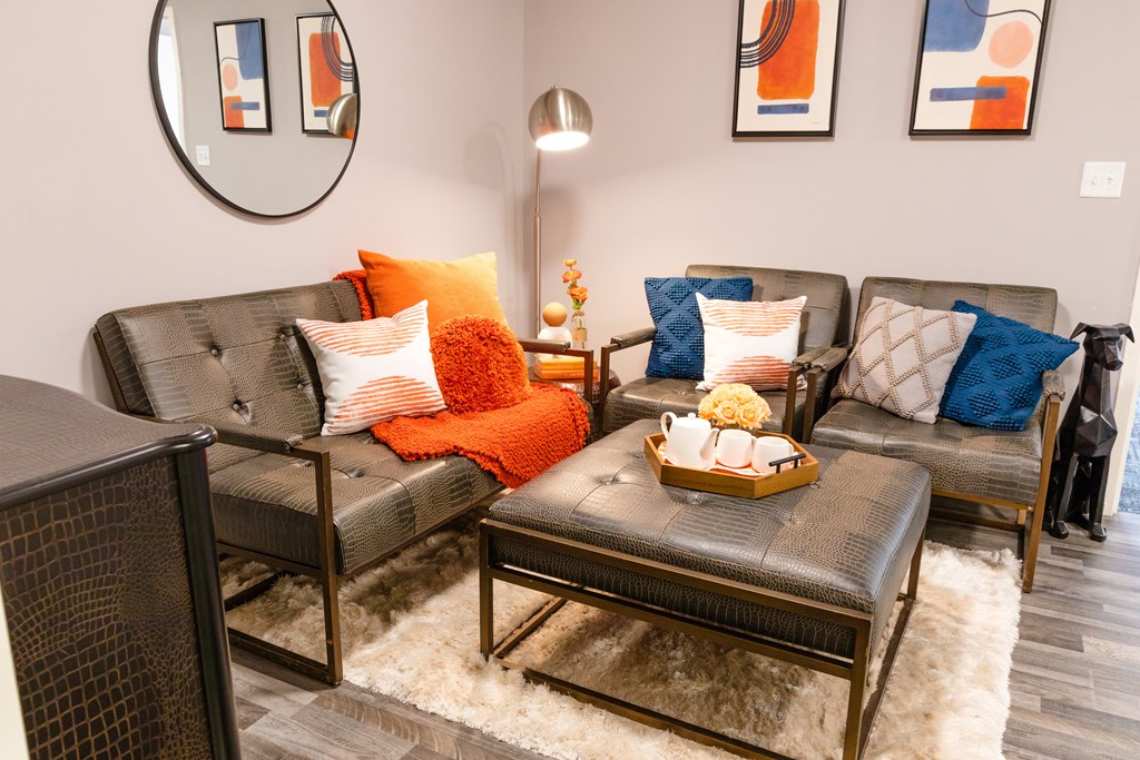 a living room with couches and pillows and a table